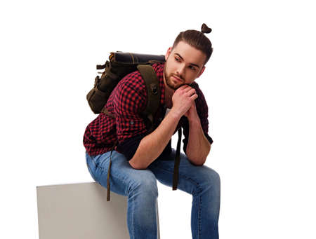 Studio portrait of bearded male dressed in a jeans and fleece shirt with a backpack. Isolated on...