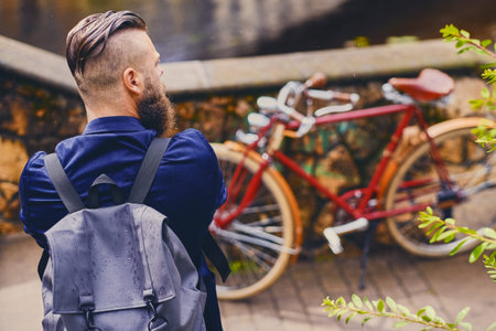 Casual modern guy with backpack. Back view.の写真素材