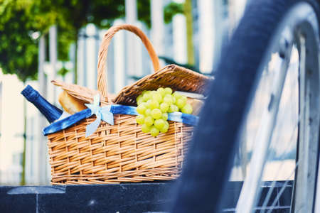 Close up image of picnic basket full of fruits, bread and wine.の写真素材