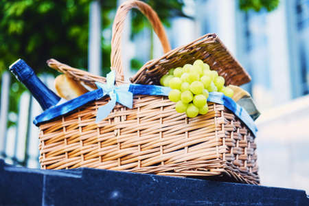 Close up image of picnic basket full of fruits, bread and wine.の写真素材