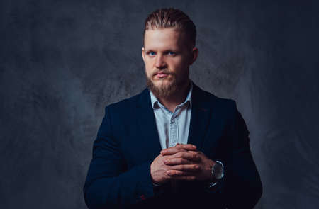 Portrait of stylish blond bearded male dressed in a suit.の写真素材