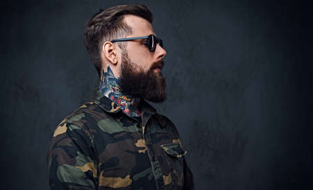 Portrait of bearded tattooed hipster male dressed in a militaryの写真素材