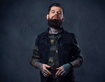 Portrait of bearded tattooed hipster male dressed in a militaryの写真素材