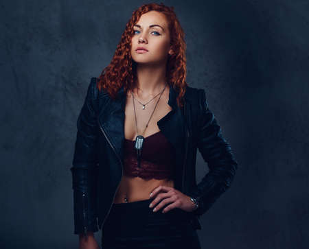Redhead female supervisor dressed in an elegant suit.