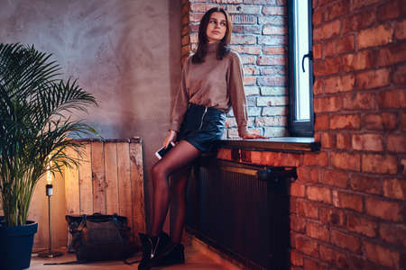 A woman posing near the window.の写真素材