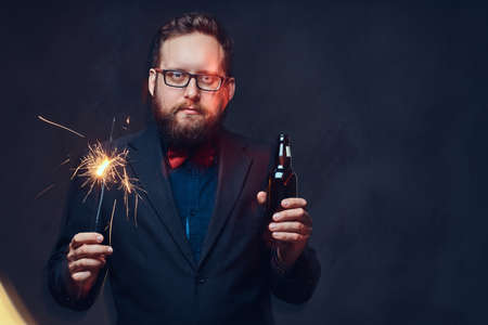 A man drinks craft beer from a bottle.