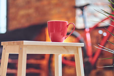 Closeup image of red coffee cup on a table.の写真素材