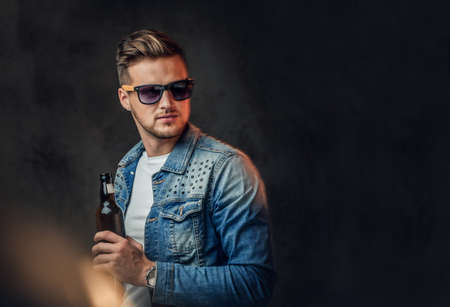 A man holds a bottle with craft beer.の写真素材