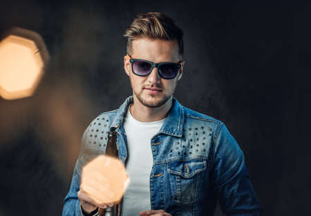 A man holds a bottle with craft beer.の写真素材