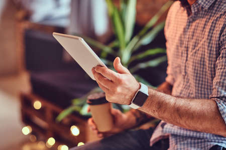 A man using tablet PC in a room.