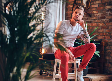 A man in a room with loft interior.の写真素材