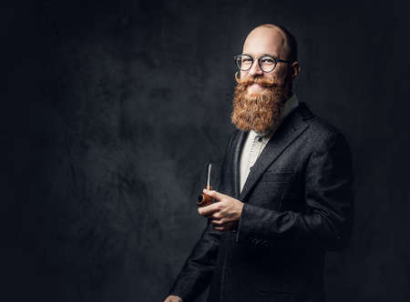 A man smoking pipe over grey background.の写真素材