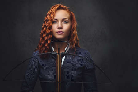 Redhead female  holds crossbow.の写真素材