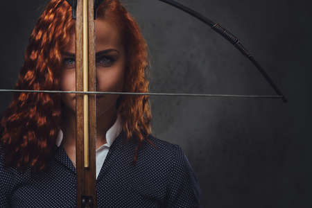 Redhead female  holds crossbow.の写真素材