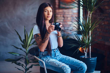 A woman takes pictures in a room with loft interior.