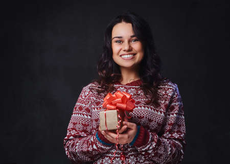 A woman holds Christmas gifts.の写真素材