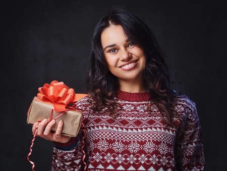 A woman holds Christmas gifts.の写真素材