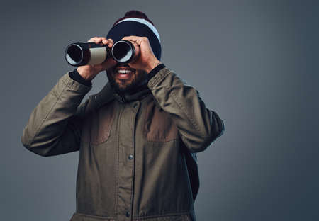 A man looking through beer bottle.の写真素材