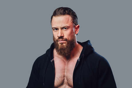 Bodybuilder in a black jacket with a hood.の写真素材