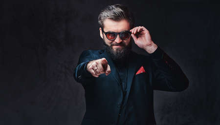 A man dressed in a suit and sunglasses.