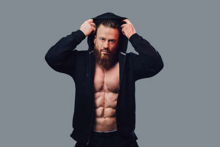 Bodybuilder in a black jacket with a hood.の写真素材