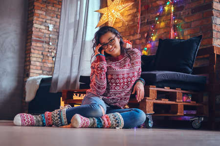 Brunette female in a room with Christmas decoration.の写真素材