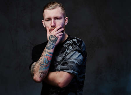 A man with tattoos on arms.