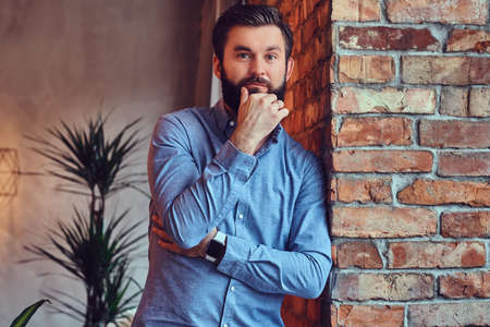 A man in a room with loft interior.の写真素材
