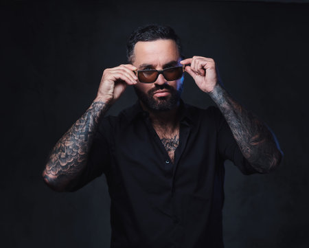 A man with tattoos on arms and neck.