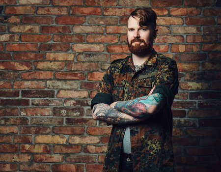 Redhead male over the wall of a brick.の写真素材