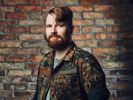 Redhead male over the wall of a brick.の写真素材