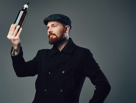 A man holds beer bottle.の写真素材