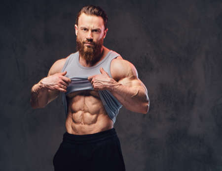Bearded bodybuilder dressed in a tank top.
