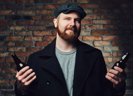 A man holds beer bottle.の写真素材