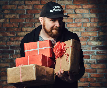 Redbeard male holds Christmas gifts.の写真素材