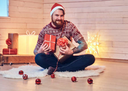 A man in a room with Christmas decoration.の写真素材