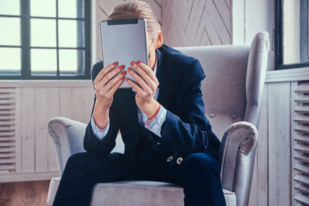 Stylish cooperative female using a tablet PC.の写真素材