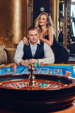 Man and woman in a casino.の写真素材