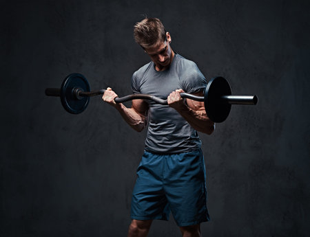 Athletic male biceps barbell workout.