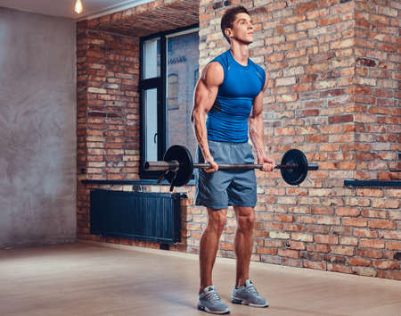 A man holds barbell.の写真素材