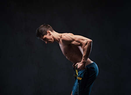 A man warms up with the latex resistance band.の写真素材
