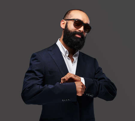 Portrait of a bearded male isolated on grey background.