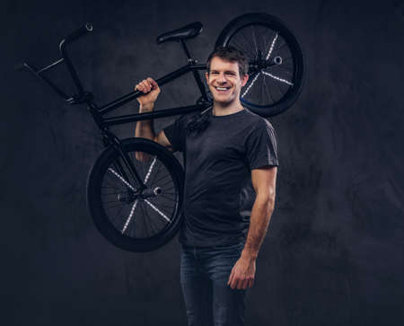 A handsome man with BMX in a studio.の写真素材