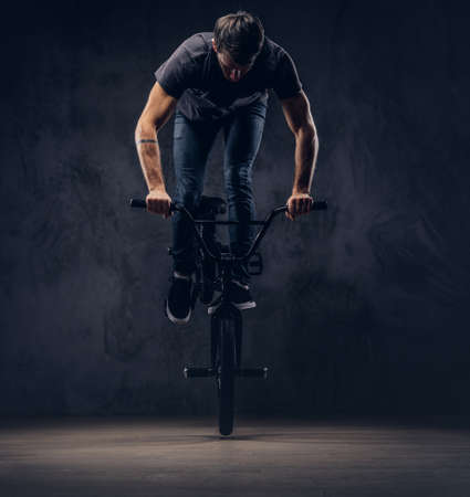 A handsome man with BMX in a studio.の写真素材