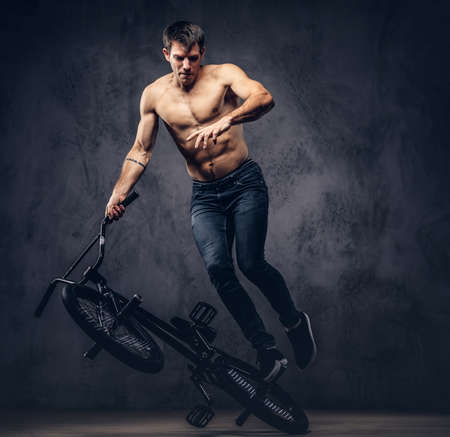 A handsome man with BMX in a studio.の写真素材