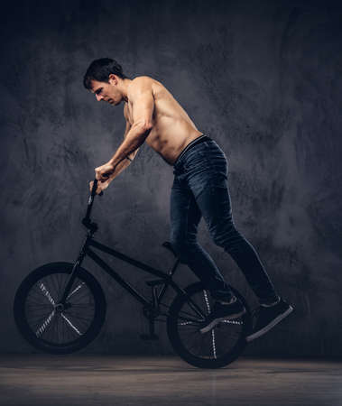 A handsome man with BMX in a studio.の写真素材