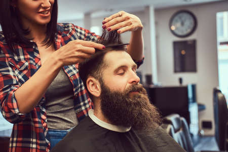 Handsome bearded man in the barbershop.