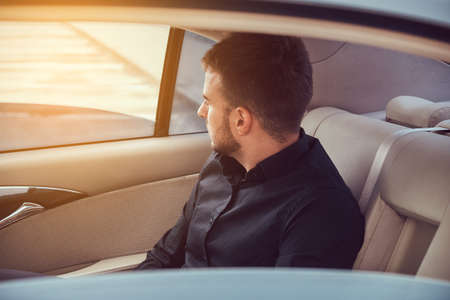 A handsome businessman in luxury carの写真素材