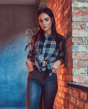 Portrait of an attractive brunette dressed in flannel shirtの写真素材