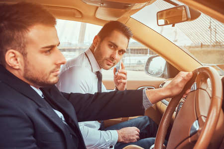 A handsome businessman in luxury carの写真素材